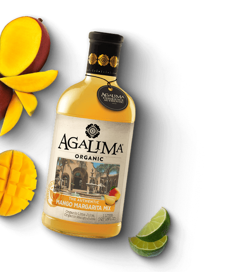 Orange bottle of Mango Margarita Mix with mangos and limes cut around it